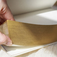 gold edges on beige linen journal