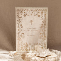 Decorative journal with floral design on a beige background with crystals