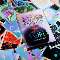 A colorful card deck box labeled 'FERTILE VOYD' sits on top of a scattered pile of illustrated tarot cards with psychedelic and fantasy artwork.