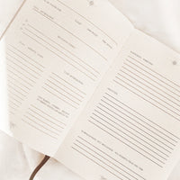 Open ritual journal with lined pages on a white background