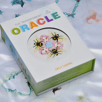 Box of 'The Transparent Oracle' cards with colorful design on a white background