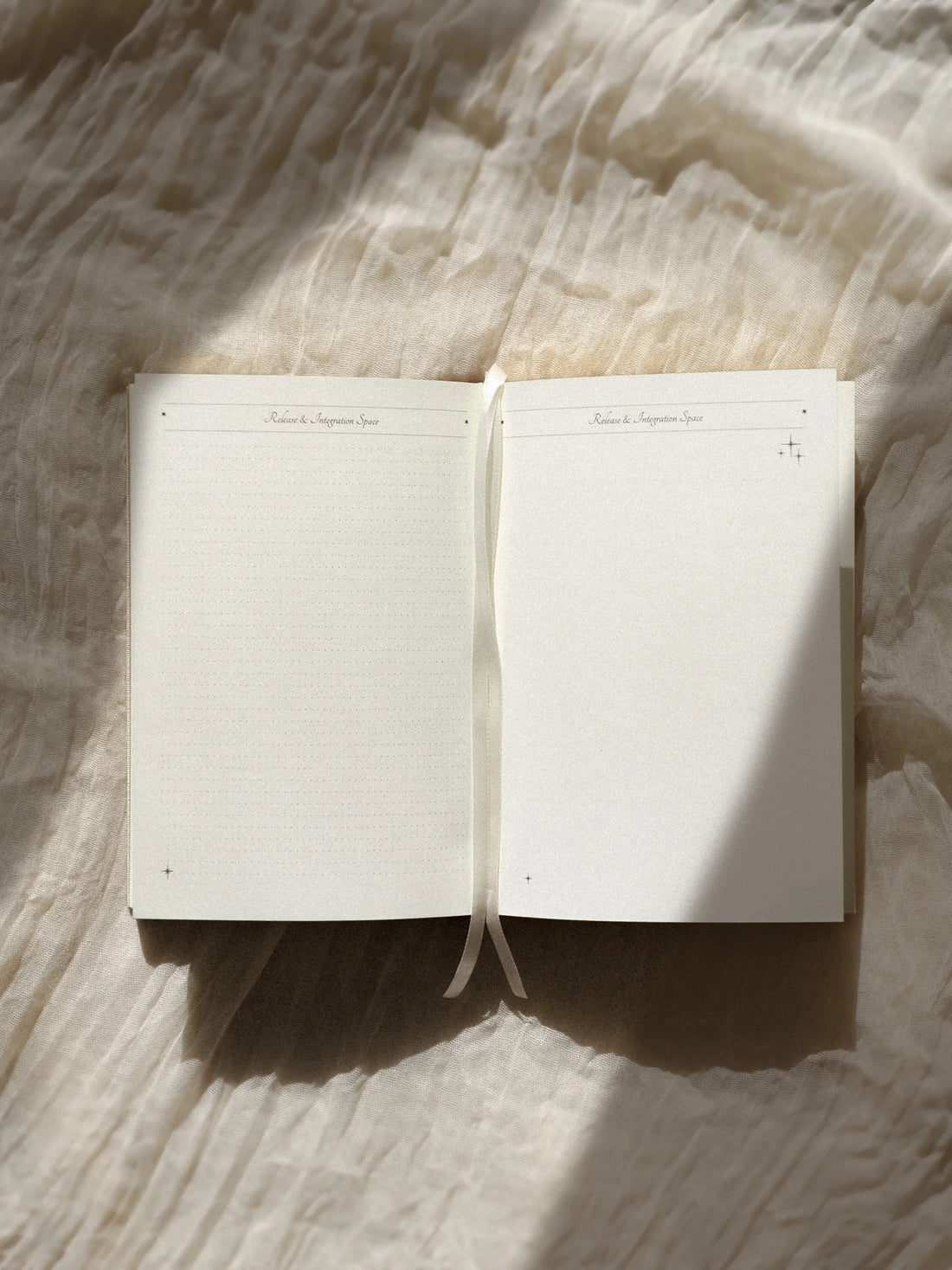 Open ritual journal on a textured fabric surface