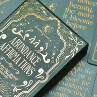 abundance affirmation deck box on top of cards. Close up shot.