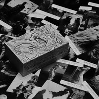 Collection of compos mentis tarot cards with intricate designs on a dark surface