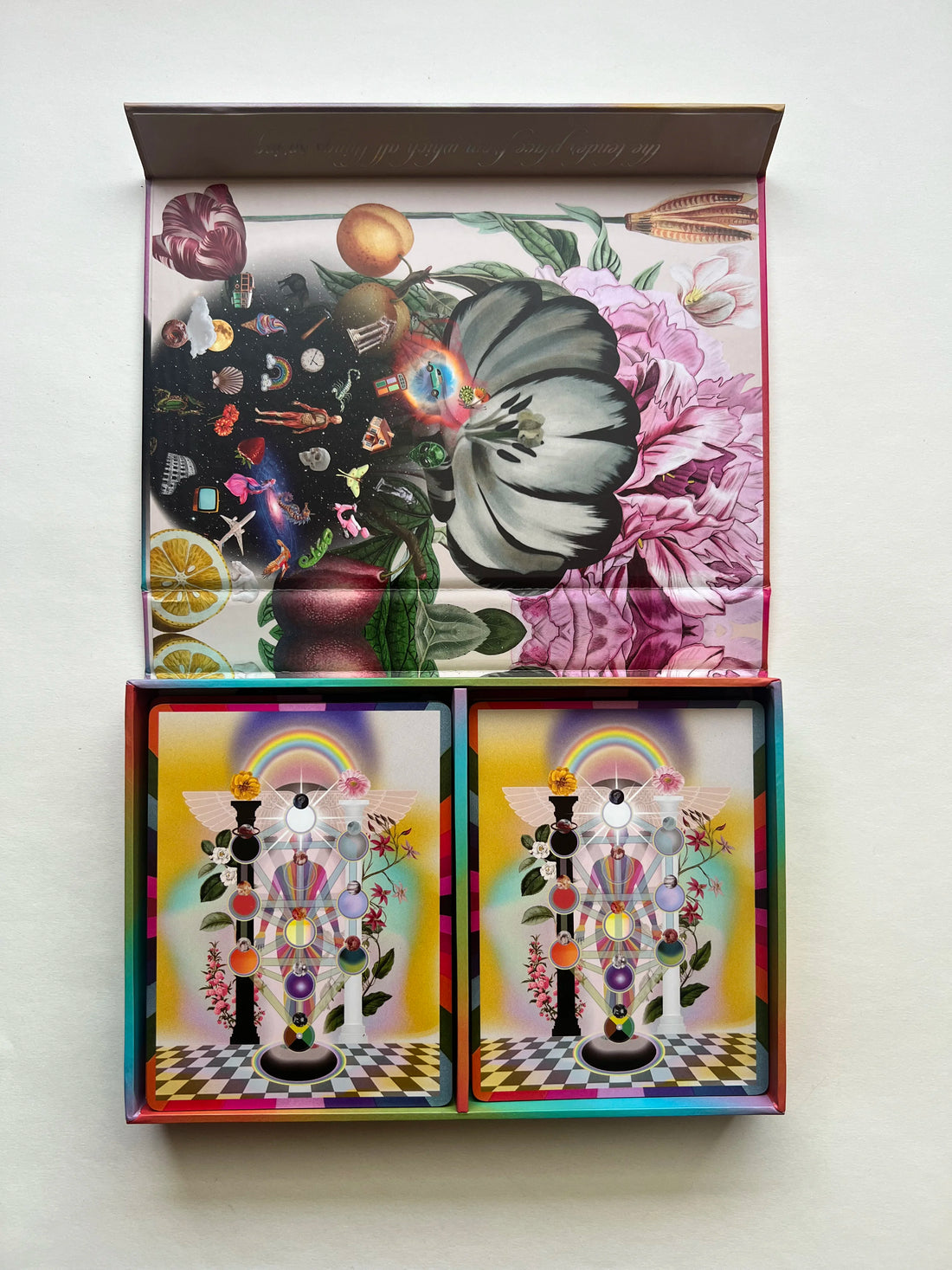 Colorful tarot cards with abstract designs in a 2 compartment box