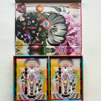 Colorful tarot cards with abstract designs in a 2 compartment box