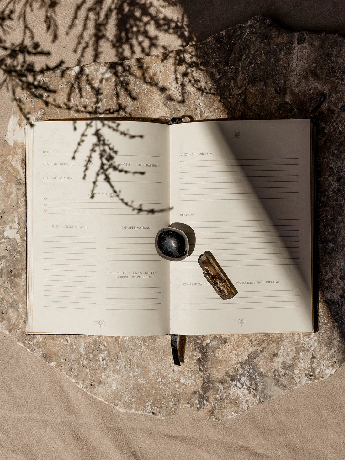 ritual journal with a crystal on a textured surface