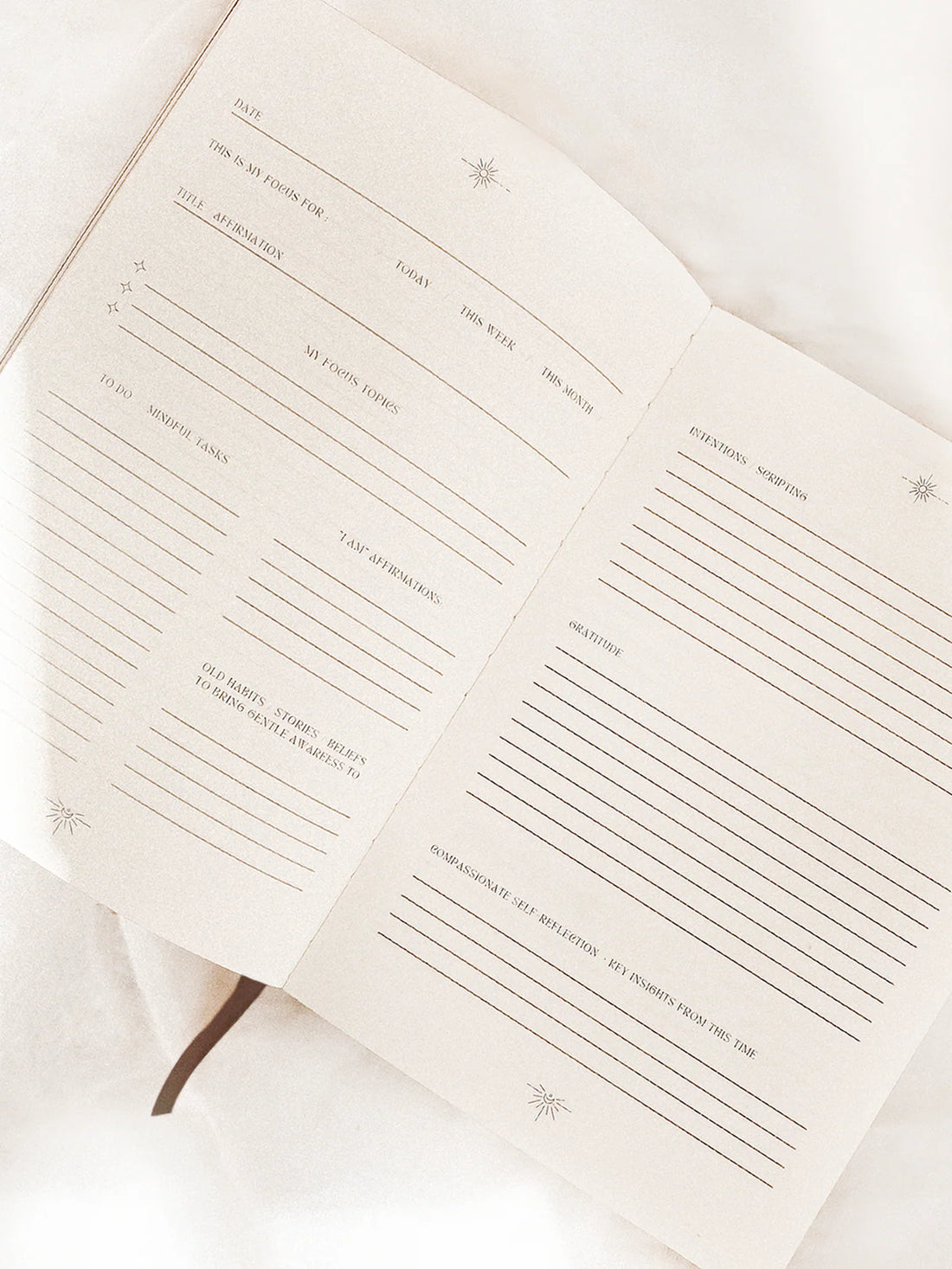 Open ritual journal with lined pages on a white background